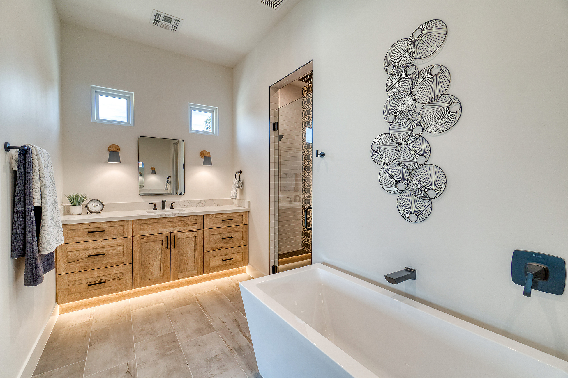 Modern bathroom remodel with walk-in shower, tile walls, and double vanity in Jacksonville NC