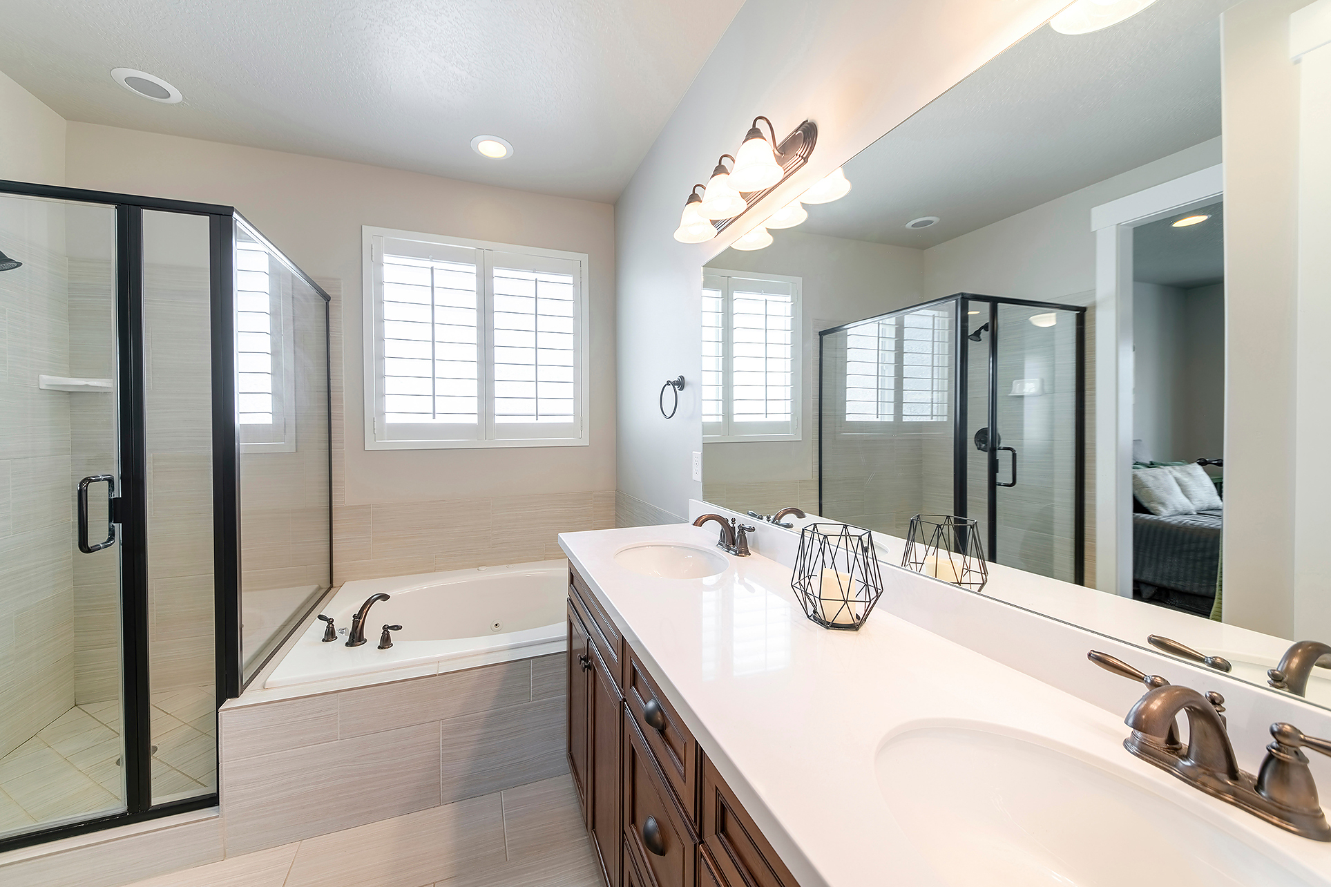 Modern bathroom remodel with walk-in shower, tile walls, and double vanity in Jacksonville NC