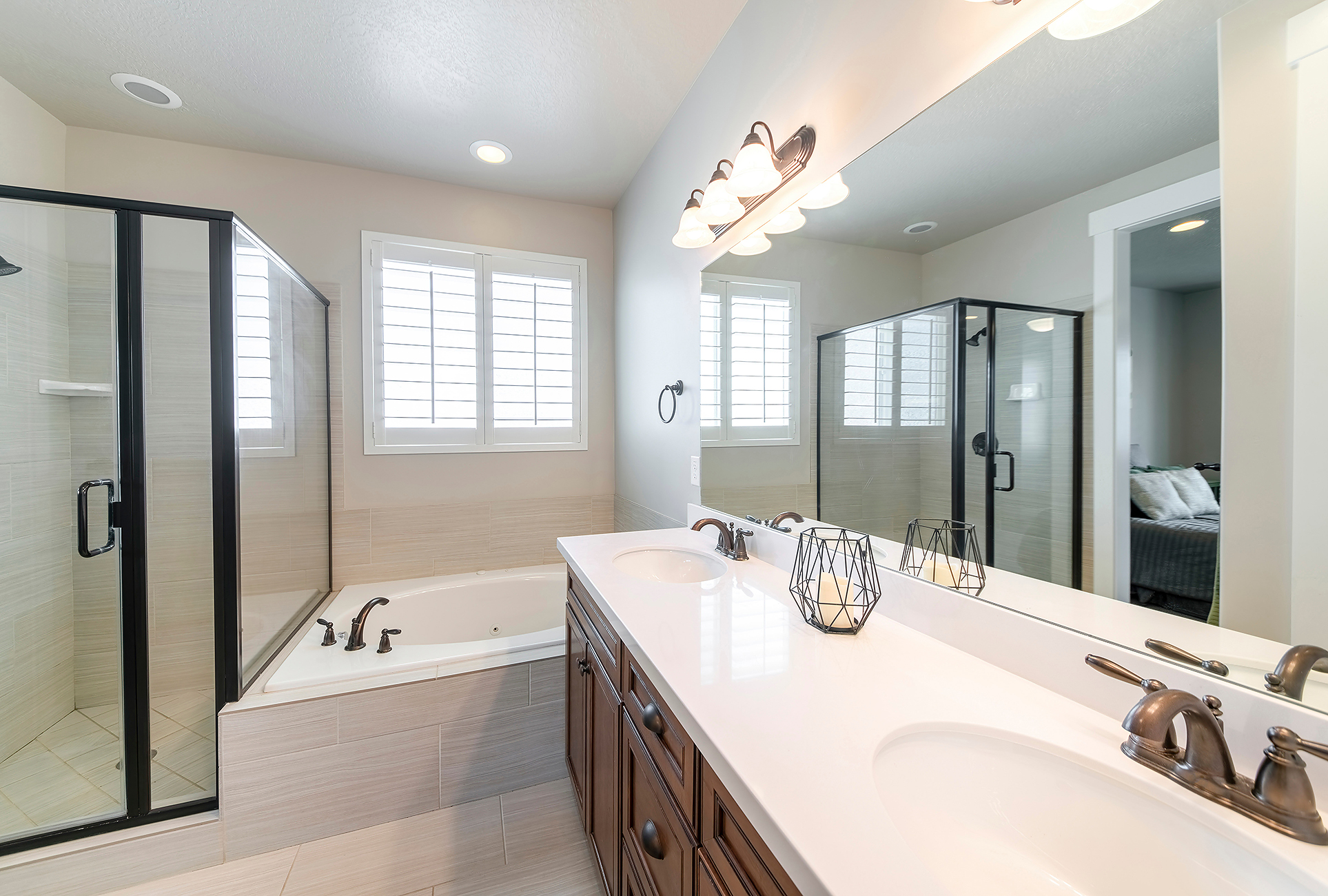 Modern bathroom remodel with walk-in shower, tile walls, and double vanity in Jacksonville NC