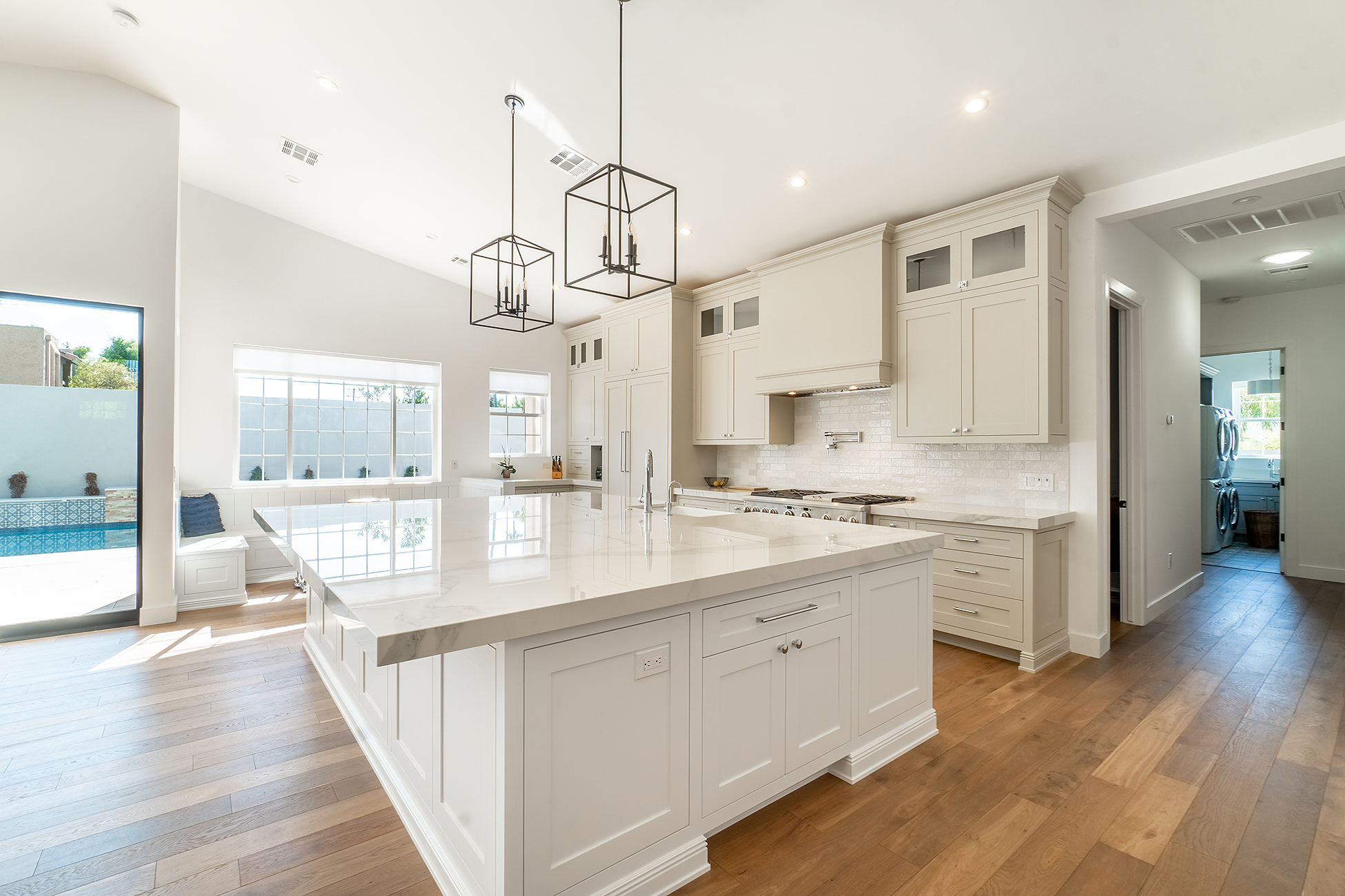 Renovated kitchen with white cabinetry, large island, and pendant lighting in Wilmington NC