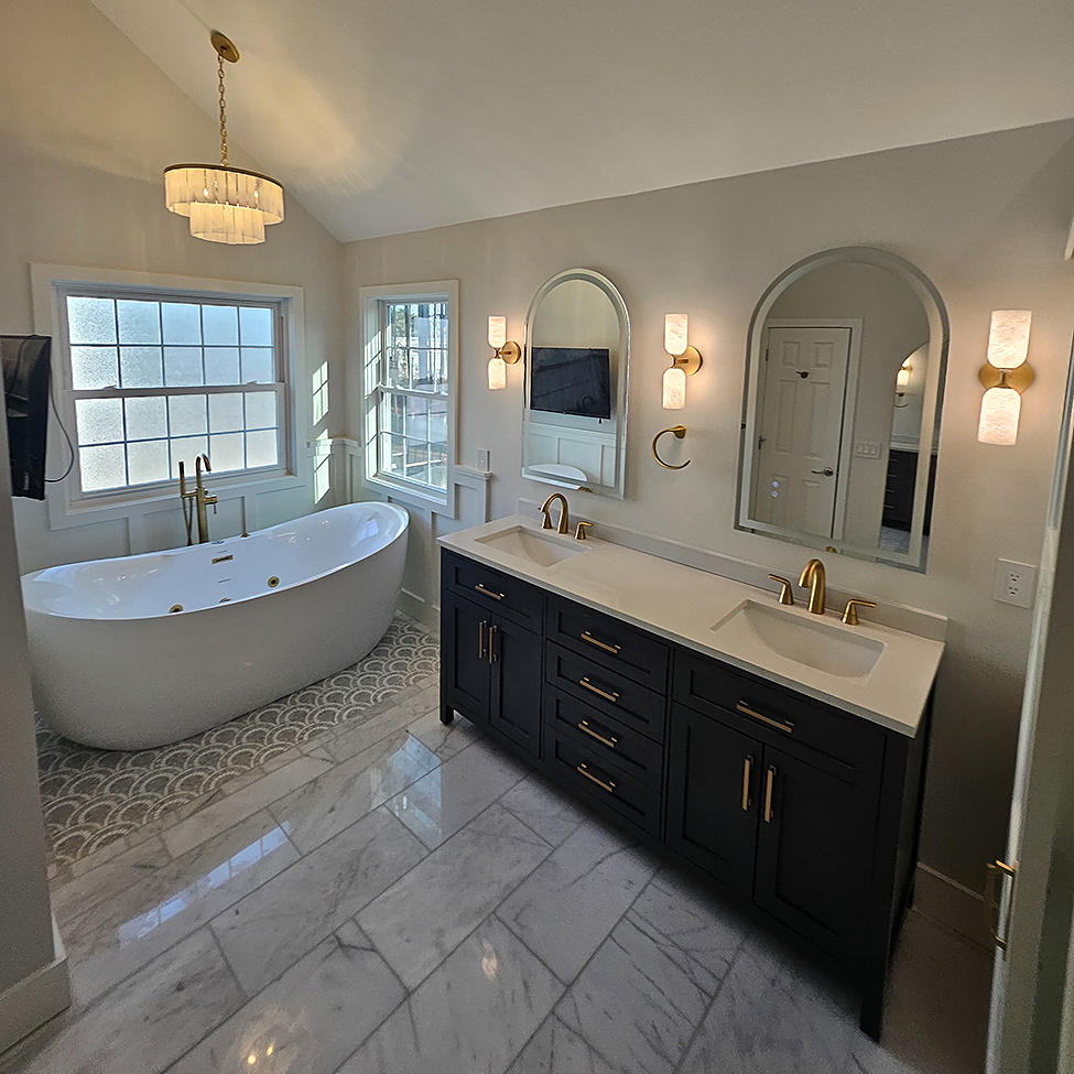 Bathroom remodel with walk-in shower, updated vanity, and clean tile finishes